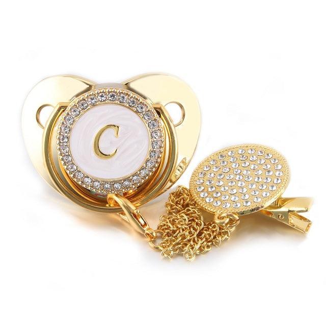 Chupeta Dourada BIBIA™ + Prendedor Strass