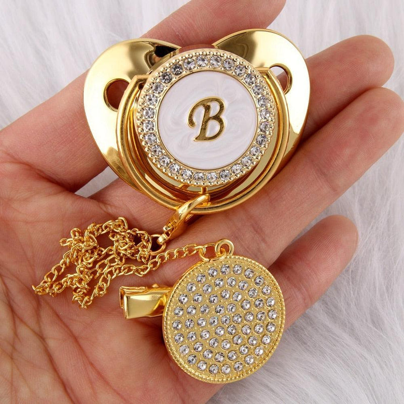 Chupeta Dourada BIBIA™ + Prendedor Strass